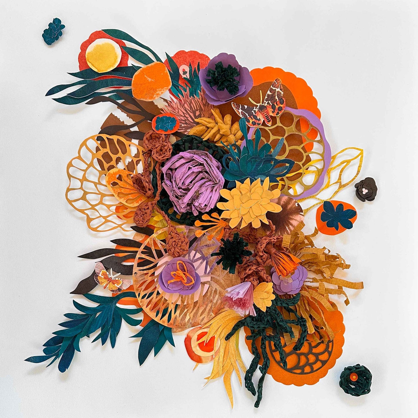 Assemblage of handmade papers that are hand cut and sculpted. Colors are orange, green, yellow, purple.